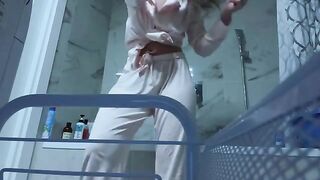 A petite girl masturbates her pussy in the bathroom alone