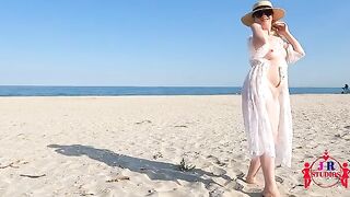 A stunning babe poses nude and engages in passionate beach sex