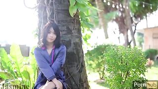 A beautiful Asian girl plays with her pussy in the garden, using a powerful vibrator