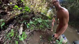 Couple make love right in the river surrounded by a jungle