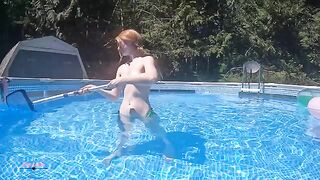 Redhead in red bikini mermaid, trying to please the cameraman