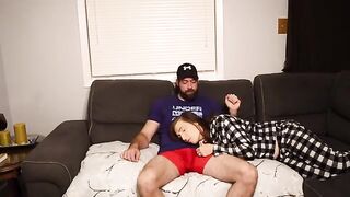 A stepmom is giving a blowjob to her stepson on the couch