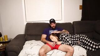 A stepmom is giving a blowjob to her stepson on the couch
