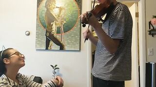 A couple trying to practice violin together with a passionate and intimate session