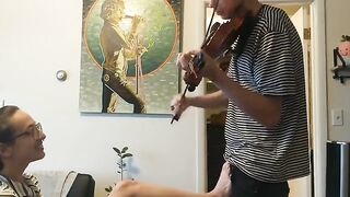 A couple trying to practice violin together with a passionate and intimate session