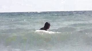 A group of girls are basking in sunbathing naked on the beach