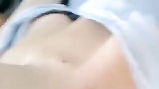 A half-naked lie and stroking her body with her hands in a sensual way