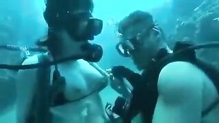 Aquatic sex of aqualangists at the bottom of the sea