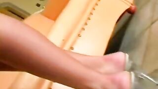 A nice girl in leather underwear masturbates on the chair with her fingers