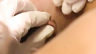 A nice brunette woman plays with her new clit piercing