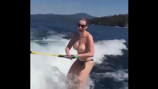 Topless beauty riding on water skiing is very exciting