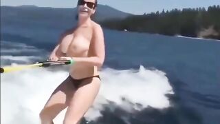 Topless beauty riding on water skiing is very exciting