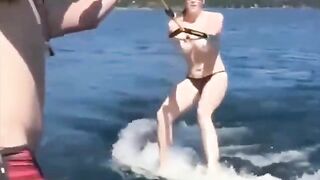 Topless beauty riding on water skiing is very exciting