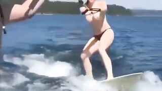 Topless beauty riding on water skiing is very exciting