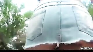 A hot brunette girl masturbating on the city streets in front of the camera