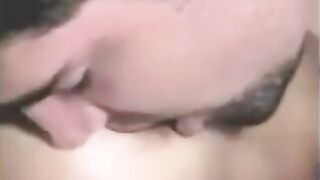 A guy fucks a strapon while another plays with his dick
