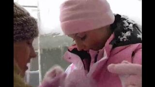 Two girls are having fun in the cold weather on a winter day