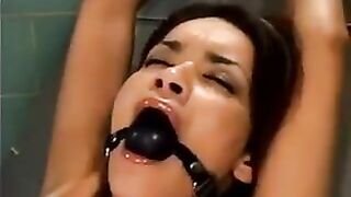 A bald guy is fucking a girl using a sex machine