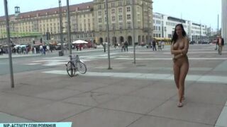 A naked girl is walking on the streets of the city, very erotic