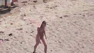 A pair of naturists sunbathing completely naked on the sea coast
