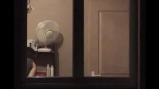 He admires his reflection in the mirror completely naked
