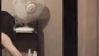 He admires his reflection in the mirror completely naked