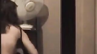 He admires his reflection in the mirror completely naked