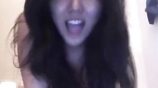 An Asian girl was masturbating on her bed and came