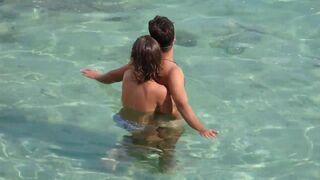 A girl fingered a guy's cock while they were underwater in the sea