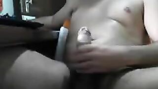 Man sits in front of the computer and masturbates his penis