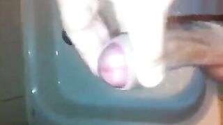 The kid caresses his cock in the shower with his hand