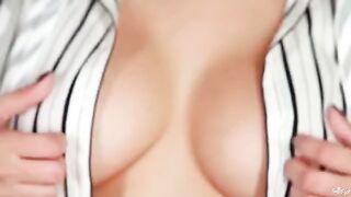 Beautiful woman with large natural breasts playing with them