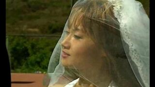 An Asian girl is having fun with a guy on the tennis court
