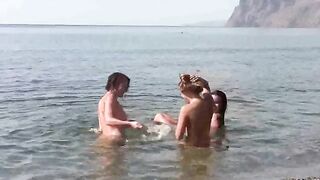 A group of nudists enjoy a day on the beach without clothes