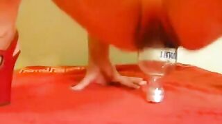 Fisting with a large dildo and a bottle in her ass
