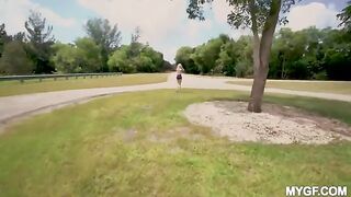 A couple enjoys fun time in the park outdoors, showcasing small tits
