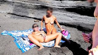 A girl undresses on the beach and masturbates with her hands