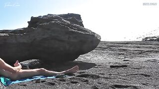 A girl undresses on the beach and masturbates with her hands