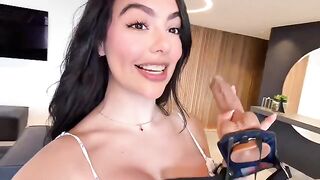 With the strap-on in her hands—they both feel like they're in heaven
